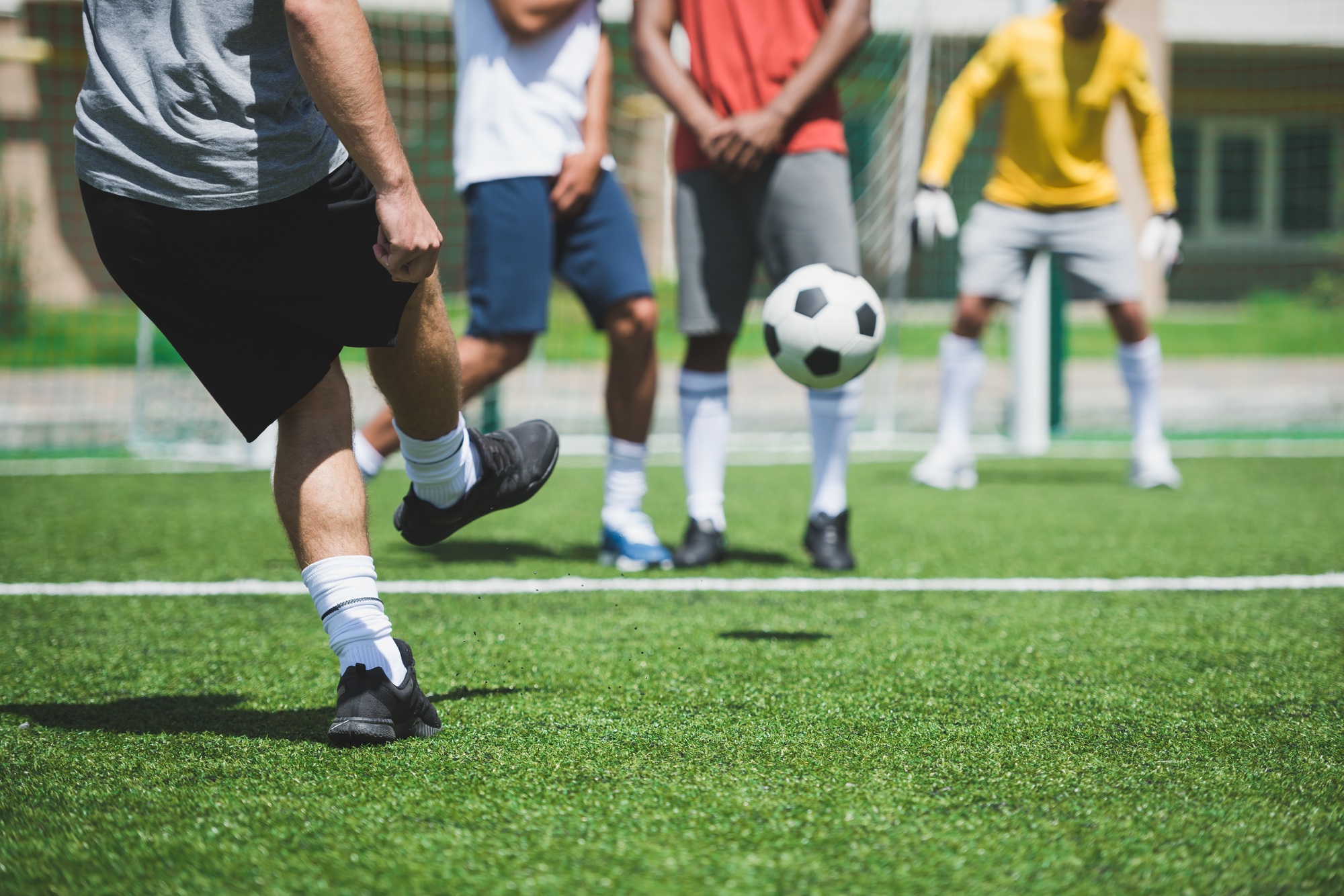 cropped shot of group of soccer players during soccer match on pitch